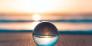 glass ball on the beach at sunset